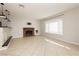 Open-concept living area with tile flooring, fireplace, and neutral wall colors at 4666 Amberwood Ln, Las Vegas, NV 89147