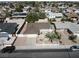 Bright aerial view of a single-story home featuring a front yard, driveway, and a street with parked cars at 4816 Greencreek Dr, Las Vegas, NV 89110