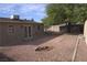 Gravel backyard features a patio, mature tree and a storage shed at 4816 Greencreek Dr, Las Vegas, NV 89110