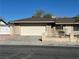 Single-story home featuring an attached garage, desert landscaping, and a secure front yard at 4816 Greencreek Dr, Las Vegas, NV 89110