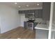 Modern kitchen featuring gray cabinetry, stainless steel appliances, and sleek countertops at 4816 Greencreek Dr, Las Vegas, NV 89110