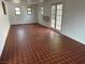 Bright living room featuring tile floors, large windows, and French doors leading to the outside at 4816 Greencreek Dr, Las Vegas, NV 89110