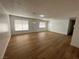 Spacious living room featuring sleek wood floors, white walls, modern lighting, and natural light at 4816 Greencreek Dr, Las Vegas, NV 89110