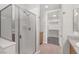 Walk-in shower and walk-in closet in ensuite bathroom with neutral tile at 50 E Serene Ave # 123, Las Vegas, NV 89123