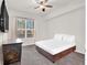 Carpeted bedroom featuring a king bed, ceiling fan, and bright window at 50 E Serene Ave # 123, Las Vegas, NV 89123