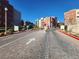 Community entrance featuring a well-maintained brick road, manicured landscaping, and secure gate access at 50 E Serene Ave # 123, Las Vegas, NV 89123