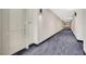 Hallway with carpet, neutral walls, and doors to individual units at 50 E Serene Ave # 123, Las Vegas, NV 89123