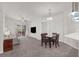 Living room with carpet, ceiling fan, dining area, and a sliding glass door to a balcony at 50 E Serene Ave # 123, Las Vegas, NV 89123