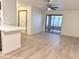 Bright living room features an open floor plan and sliding glass door to the balcony at 5121 Lindell Rd # 104, Las Vegas, NV 89118