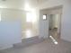 Open living room with light wood floors, neutral paint and staircase at 5490 Floating Flower Ave, Las Vegas, NV 89139