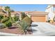 Inviting home exterior with a well-manicured front yard and a terracotta tile roof at 5517 Whiteleaf Ct, Las Vegas, NV 89149