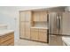 Kitchen area with stainless steel refrigerator and lots of cabinets with tile countertops at 5517 Whiteleaf Ct, Las Vegas, NV 89149