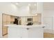 Bright kitchen with a breakfast bar, white tile, stainless steel appliances, and access to the dining area at 5517 Whiteleaf Ct, Las Vegas, NV 89149