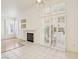 Light-filled living room with a fireplace and French doors leading to the outdoor pool at 5517 Whiteleaf Ct, Las Vegas, NV 89149