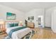 The staged main bedroom includes a calming color palette, matching nightstands, a dresser, and en-suite access at 5517 Whiteleaf Ct, Las Vegas, NV 89149