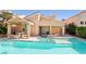 Inviting backyard pool and spa with covered patio and ample seating; perfect for relaxation and entertaining at 5517 Whiteleaf Ct, Las Vegas, NV 89149