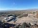 Aerial view of the luxury home construction site showing the surrounding desert landscape and city skyline at 563 Rock Peak Dr, Henderson, NV 89012