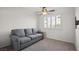 Comfortable bedroom featuring a gray sofa and shuttered window for natural light at 6316 Canyon Ridge Dr, Las Vegas, NV 89108