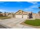 Front exterior featuring a three-car garage and well-maintained desert landscaping at 6316 Canyon Ridge Dr, Las Vegas, NV 89108