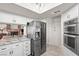 Updated kitchen featuring stainless appliances, white cabinets and granite countertops at 6316 Canyon Ridge Dr, Las Vegas, NV 89108