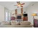 Inviting living room features a stone fireplace and french doors at 6316 Canyon Ridge Dr, Las Vegas, NV 89108