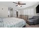 Comfortable main bedroom featuring a ceiling fan, dresser, and a cozy gray chair with ottoman at 6316 Canyon Ridge Dr, Las Vegas, NV 89108