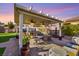 Covered patio with ceiling fans featuring a built-in grill and a dining area with a fountain at 6316 Canyon Ridge Dr, Las Vegas, NV 89108