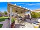 Covered patio with ceiling fans featuring a built-in grill and a dining area with a fountain at 6316 Canyon Ridge Dr, Las Vegas, NV 89108