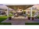 An impressive outdoor kitchen and dining area under a beautiful pergola at 6316 Canyon Ridge Dr, Las Vegas, NV 89108