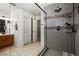 Elegant bathroom featuring a glass-enclosed shower with dual heads, bench, and neutral stone surround at 6316 Canyon Ridge Dr, Las Vegas, NV 89108