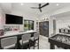 Modern bar area with a counter, stools, wine refrigerators and a television at 632 Canyon Greens Dr, Las Vegas, NV 89144