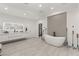 Bright, modern bathroom with a soaking tub, vanity, and a separate walk-in closet at 632 Canyon Greens Dr, Las Vegas, NV 89144