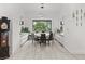 Bright dining room with a large window, modern light fixture, and seating for eight guests at 632 Canyon Greens Dr, Las Vegas, NV 89144