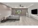 Modern bedroom featuring a platform bed, sleek built-ins, and a large window with a serene view at 632 Canyon Greens Dr, Las Vegas, NV 89144