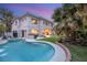 Backyard pool with a built-in jacuzzi, outdoor kitchen and palm trees creates an elegant outdoor living space at 632 Canyon Greens Dr, Las Vegas, NV 89144