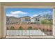 Balcony view with a clear blue sky, neighboring houses, privacy wall, and fence at 6489 Little Harbor Ct, Las Vegas, NV 89141