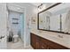 Bathroom with double sink vanity, framed mirror, and tub/shower combo at 6489 Little Harbor Ct, Las Vegas, NV 89141