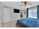 Bedroom featuring a ceiling fan, flat screen tv, and a view of a full bathroom at 6489 Little Harbor Ct, Las Vegas, NV 89141