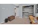 Cozy bedroom featuring closet with organizers, basket, desk, neutral walls, and carpeted floor at 6489 Little Harbor Ct, Las Vegas, NV 89141