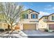 Charming two-story home featuring a paved driveway, two-car garage, and desert landscaping at 6489 Little Harbor Ct, Las Vegas, NV 89141