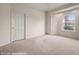 Bright bedroom featuring neutral carpet, a window, and a spacious layout at 701 Aztec Cir, Mesquite, NV 89027