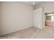 Bedroom featuring beige walls, carpet, ceiling fan, and bathroom access at 701 Aztec Cir, Mesquite, NV 89027