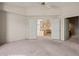 Bedroom with plush carpet and doors leading to the kitchen and a patterned bathroom at 701 Aztec Cir, Mesquite, NV 89027