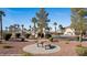 Relaxing common area with stone benches, landscaping, and palm trees at 701 Aztec Cir, Mesquite, NV 89027