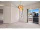 Dining area with neutral carpet, stylish chandelier, and sliding door to the outdoors at 701 Aztec Cir, Mesquite, NV 89027