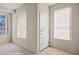 Bright entryway with tile floor, white door, and natural light from two windows at 701 Aztec Cir, Mesquite, NV 89027