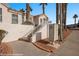 Beautiful home with a staircase, white railings, desert landscaping, and convenient community mailboxes at 701 Aztec Cir, Mesquite, NV 89027