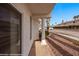 Inviting home exterior featuring covered porch entry with decorative column and desert landscaping at 701 Aztec Cir, Mesquite, NV 89027