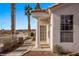 Welcoming home featuring a covered porch with decorative column, desert landscaping and red tiled roof at 701 Aztec Cir, Mesquite, NV 89027