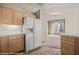 Kitchen with wood cabinets and white appliances, showing entry to living space at 701 Aztec Cir, Mesquite, NV 89027